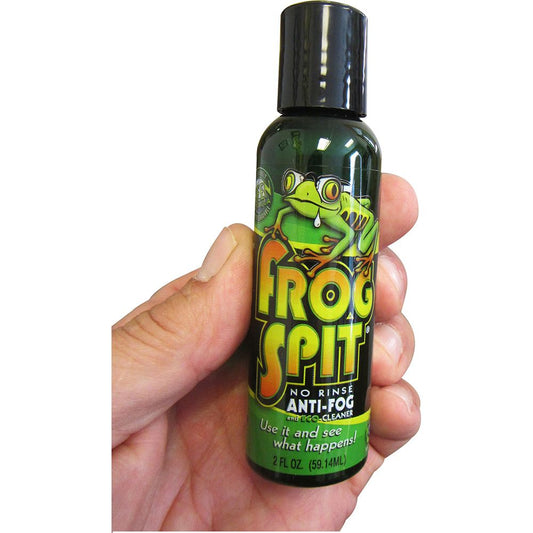 Frog Spit anti-fog solution bottle held in hand, showing 2 fl oz no-rinse formula for diving masks and goggles