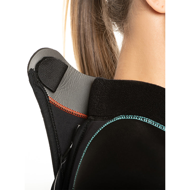 Close-up of a person wearing a black wetsuit with gray shoulder padding.