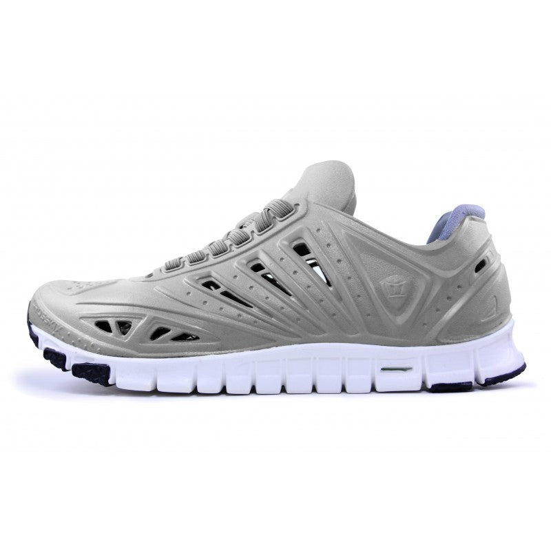 Crosskix APX Greystone athletic shoe side profile view showing grey upper with perforated design details, white sole with blue accents, and flexible outsole pattern
