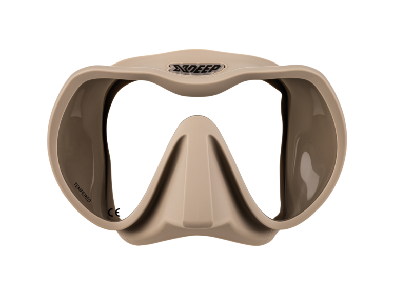 XDEEP beige silicone low-profile dive mask with clear frame and desert sand skirt, front view.