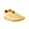Side profile view of Crosskix Tetra Sand shoe displaying cream upper with honeycomb perforations, golden yellow accents, and 'CROSSKIX' branding on midsole