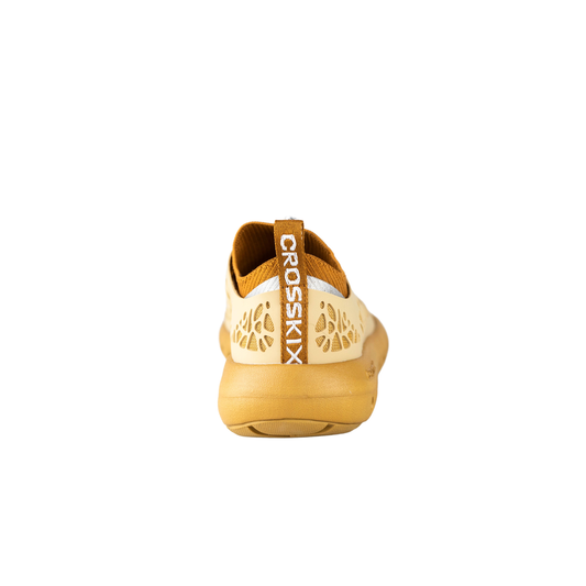 Back view of Crosskix Tetra Sand shoe showing cream-colored heel with honeycomb perforations and 'CROSSKIX' branding on the heel tab