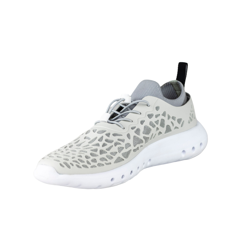 Side profile of white Crosskix Tetra Stone water shoe showing breathable mesh upper with decorative perforations, lace-up closure with gray accents, and thick white cushioned sole