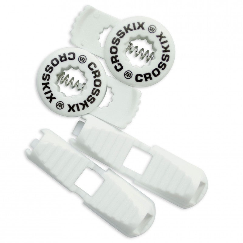 Crosskix elastic shoelace components laid out showing two white  lace clips and two circular Crosskix branded end caps with logo design
