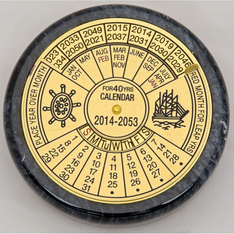 Round rotating brass calendar for the years 2014–2053, with engraved wheel and ship icons, ideal as a nautical desk accessory.