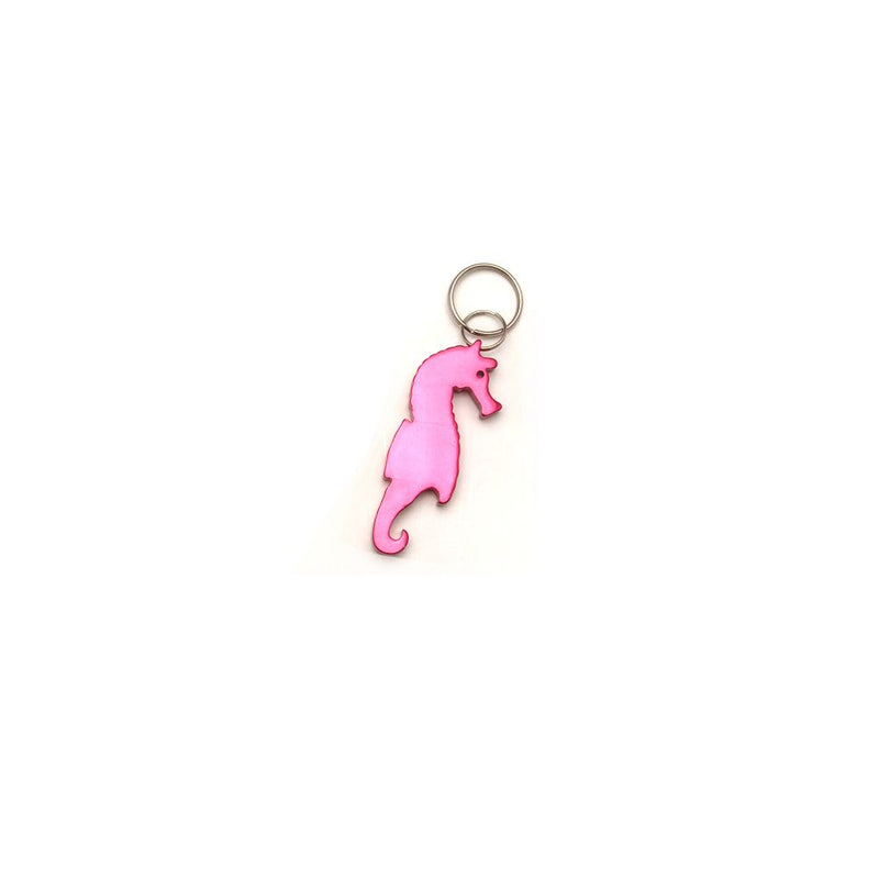 Neon pink aluminum keychain in the shape of a seahorse with eye cutout and split ring, serves as both a charm and bottle opener.