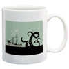 Giant octopus attacking sailing ship with seagulls flying overhead on mint green and black background printed on white ceramic coffee mug