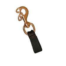Bronze/brass colored spring clip with black webbing attachment for dive gear