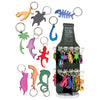 Collection of colorful bottle opener keychains in various marine-themed shapes including fish, sharks, dolphins, sea turtle, octopus, and palm tree, displayed alongside a retail display stand containing multiple keychains from Innovative Scuba Concepts