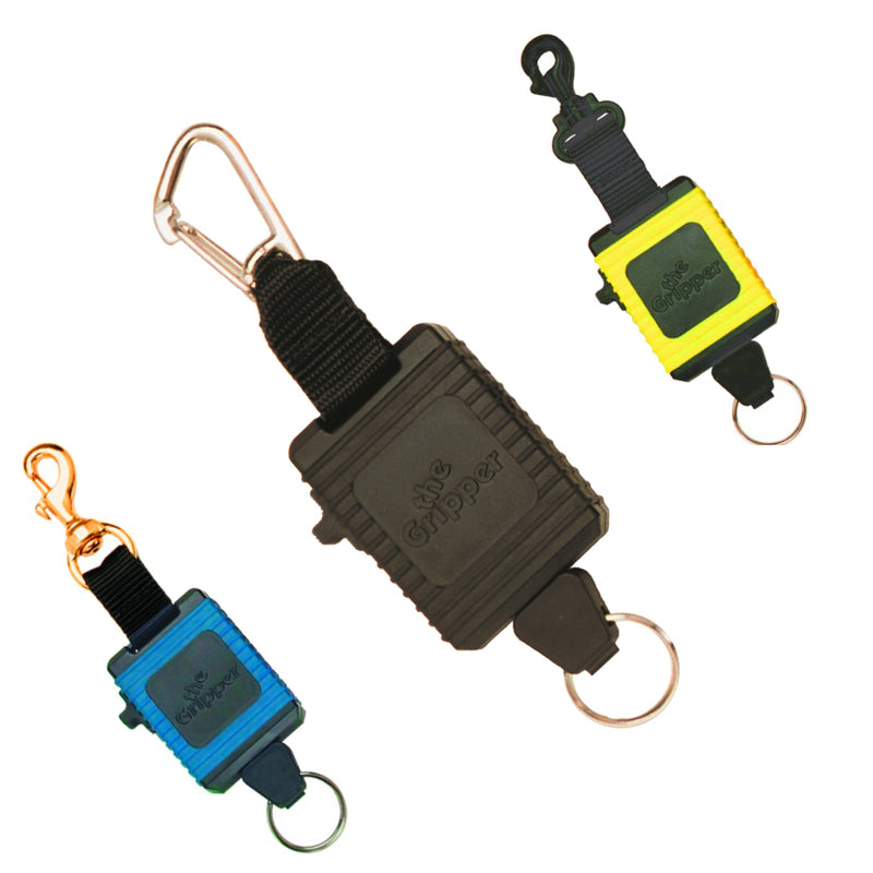 Innovative Scuba Concepts 'The Gripper' retractable gear holders in black, yellow, and blue color variations, each featuring a secure clip and key ring attachment, displayed on a white background.