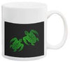 White ceramic mug with black background featuring green sea turtle design